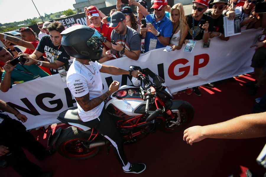 Lewis Hamilton on his motorbike with the fans