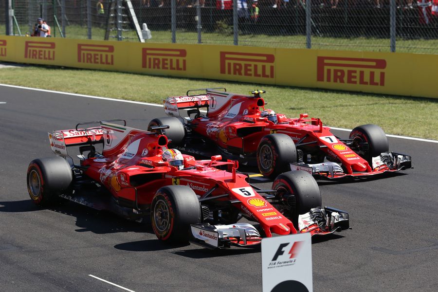 Pole sitter Sebastian Vettel and Kimi Raikkonen in parc ferme