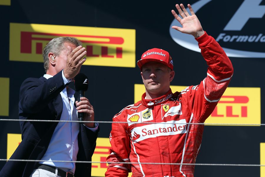 Kimi Raikkonen celebrates on the podium with David Coulthard