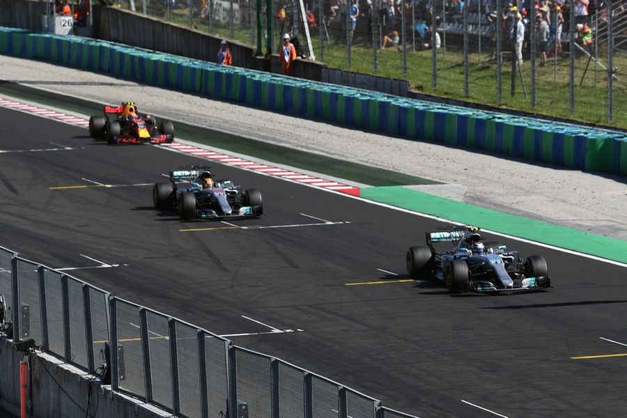 Valtteri Bottas and Lewis Hamilton cross the line