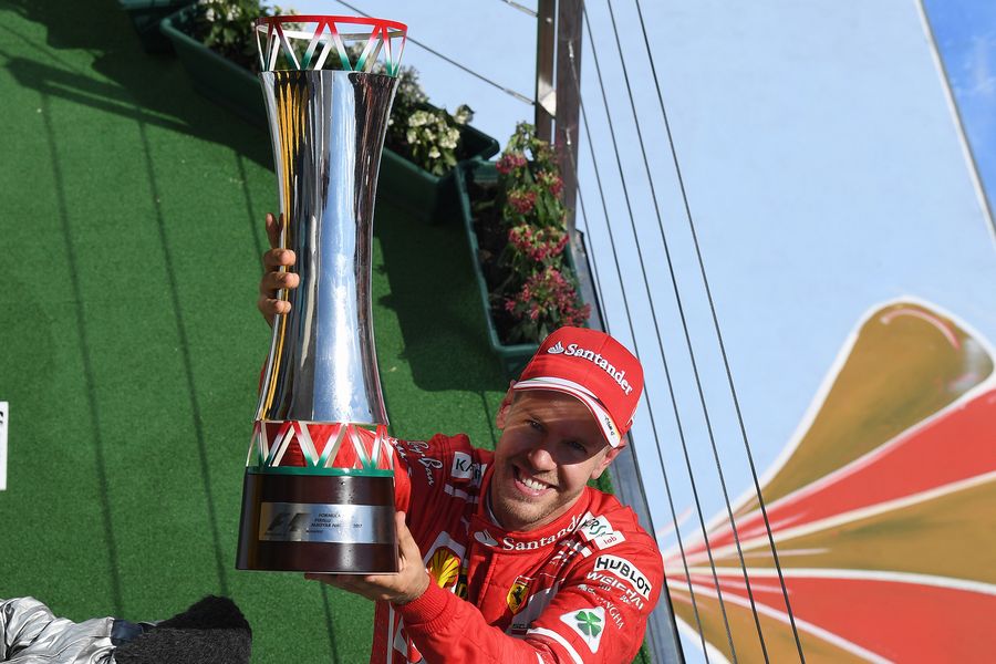 Sebastian Vette celebrates on the podium with the trophy