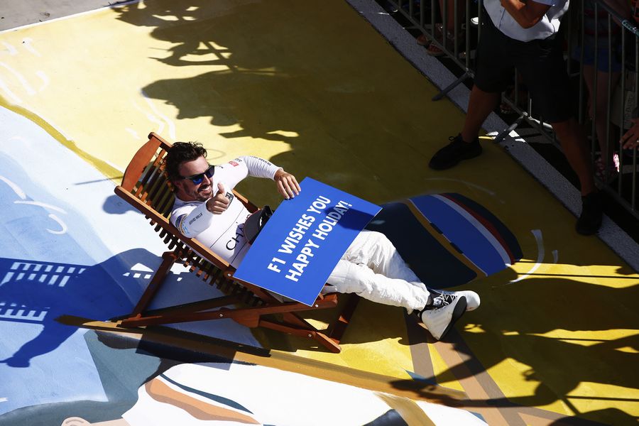 Fernando Alonso in a deck chair in parc ferme