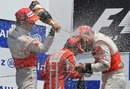 Lewis Hamilton and Jenson Button celebrate on the podium