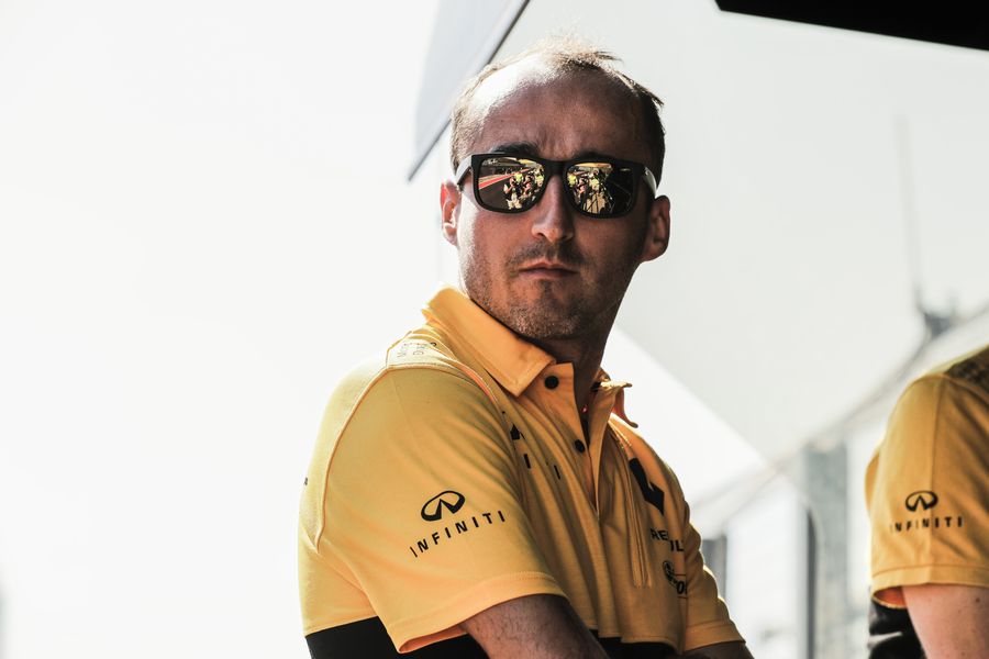Robert Kubica stands on the pit wall
