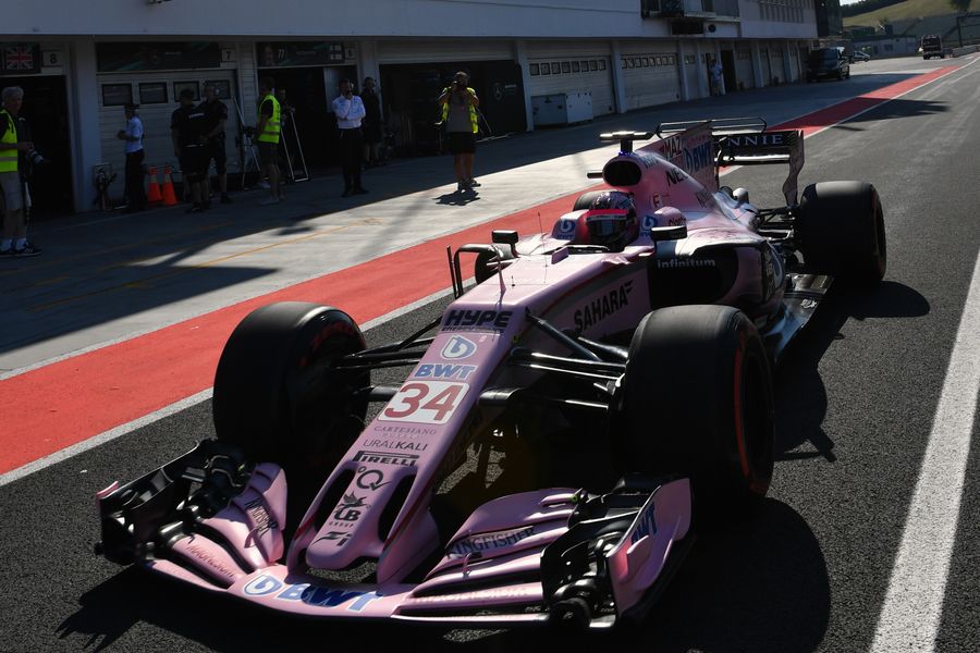 Nikita Mazepin powers down the pit lane in the Force India