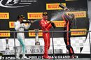 Race winner Lewis Hamilton celebrates on the podium with Sebastian Vettel and Daniel Ricciardo with the champagne