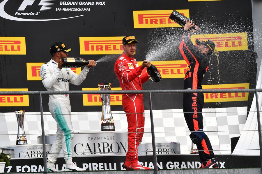 Race winner Lewis Hamilton celebrates on the podium with Sebastian Vettel and Daniel Ricciardo with the champagne