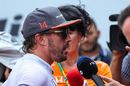 Fernando Alonso talks with the media