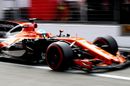 Fernando Alonso powers down the pit lane in the McLaren