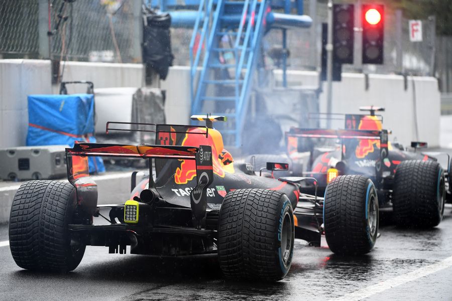 Max Verstappen and Daniel Ricciardo waits at the red light at the end of pit lane