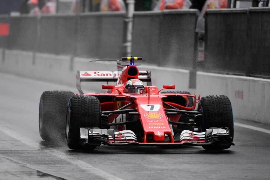 Kimi Raikkonen powers down the pit lane in the Ferrari