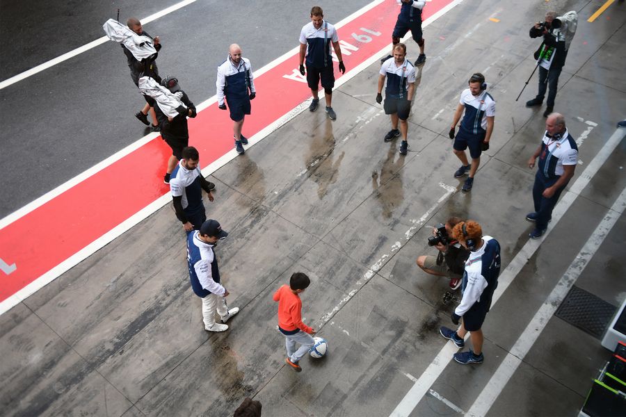 Felipe Massa and the Williams mechanics play football in pit lane