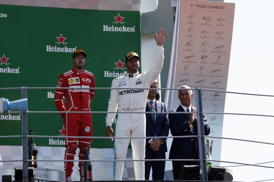 Race winner Lewis Hamilton and Sebastian Vettel celebrate on the podium