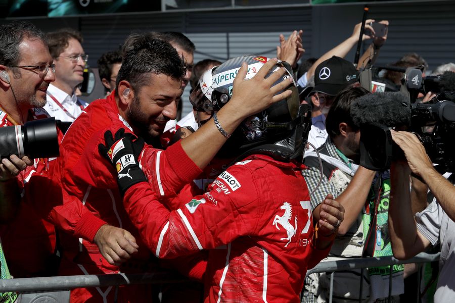 Sebastian Vettel celebrates in parc ferme with the team