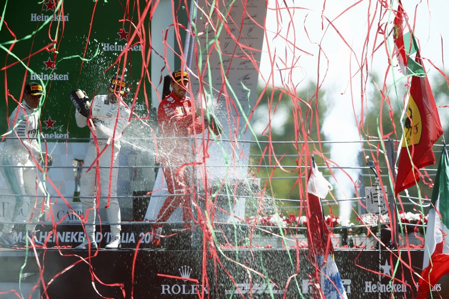 Lewis Hamilton, Valtteri Bottas and Sebastian Vettel celebrate on the podium with the champagne