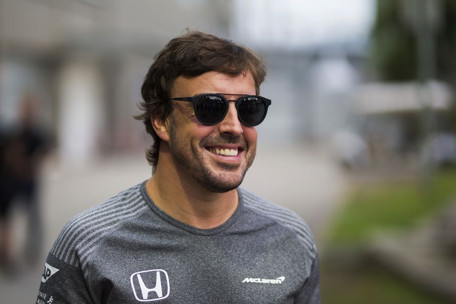Fernando Alonso looks relaxed in the paddock
