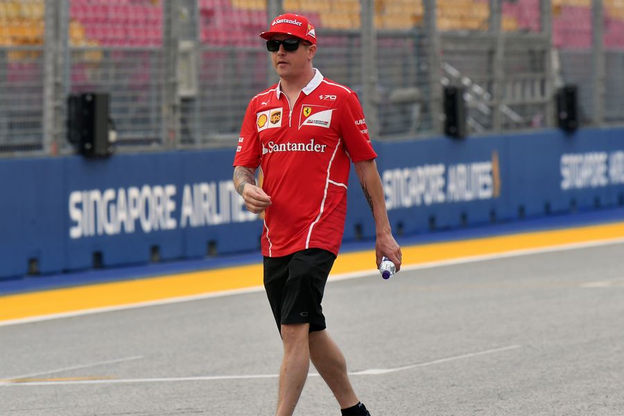 Kimi Raikkonen walks the track
