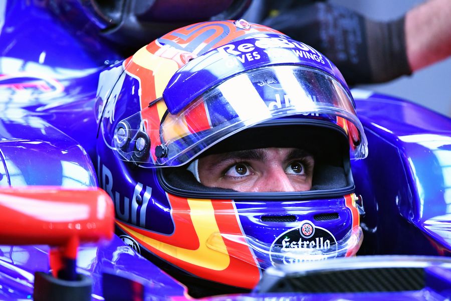 Carlos Sainz jr sits in the Toro Rosso cockpit