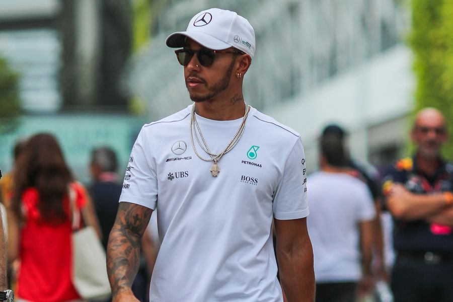 Lewis Hamilton walks through the paddock