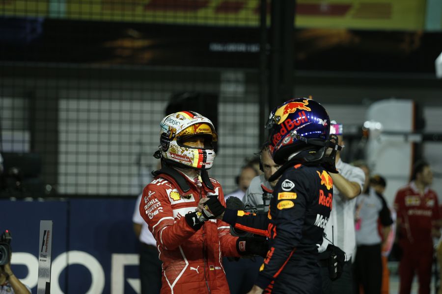 Pole sitter Sebastian Vettel celebrates in parc ferme with Max Verstappen