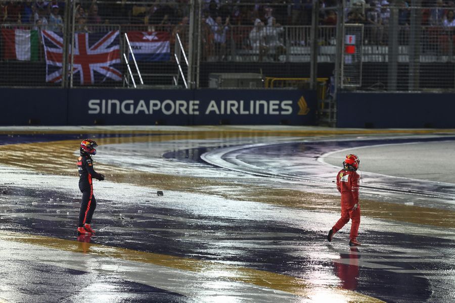 Kimi Raikkoneni and Max Verstappen walk in after crashing at race start