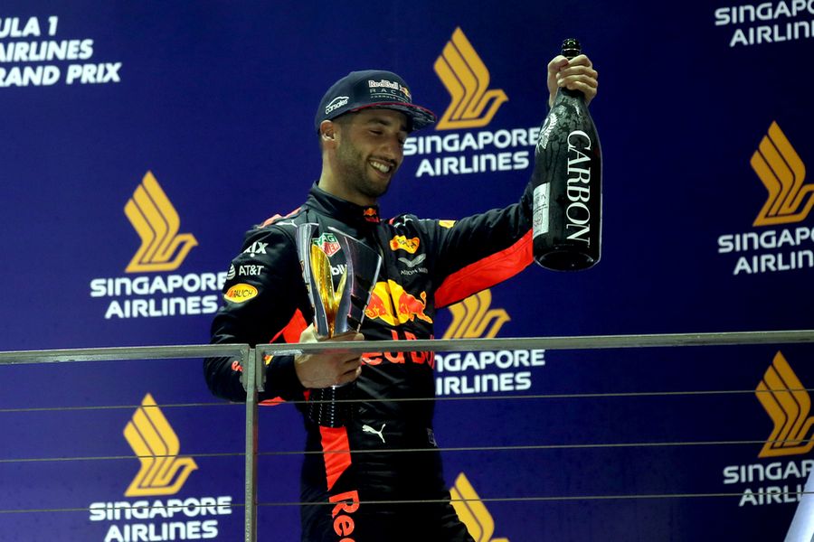 Daniel Ricciardo Celebrates on the podium with the trophy and champagne