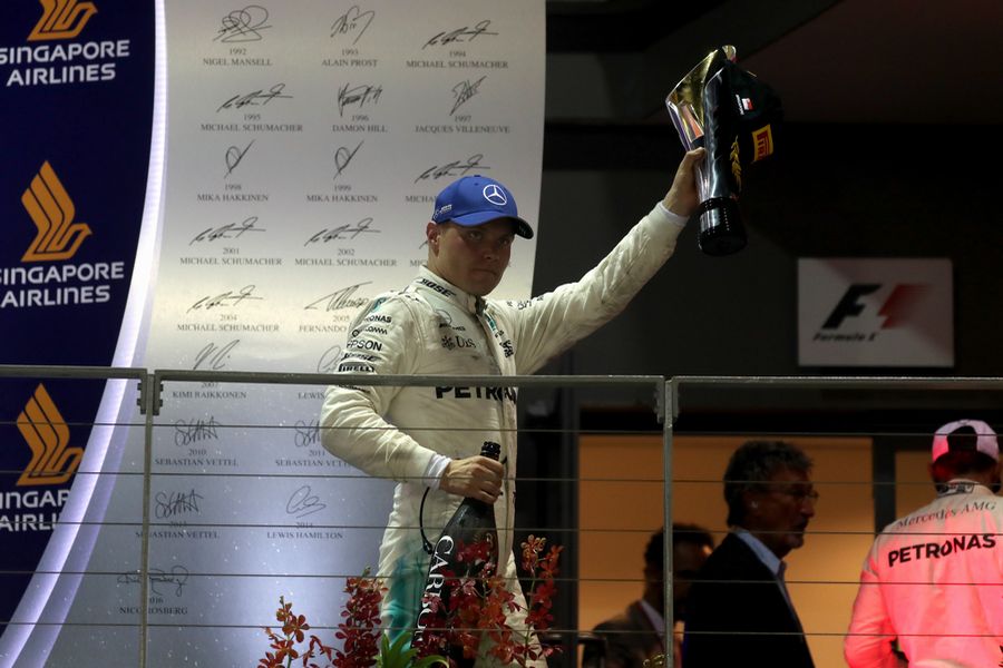 Valtteri Bottas Celebrates On the podium with the champagne and the trophy
