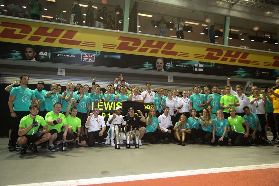 Race winner Lewis Hamilton celebrates with Valtteri Bottas and the team