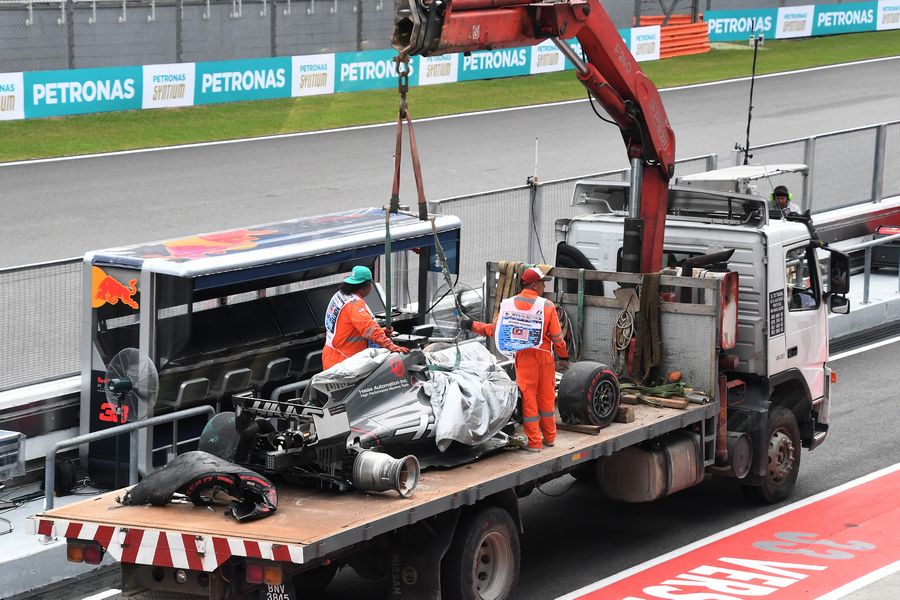 The crashed car of Romain Grosjean is recovered in FP2