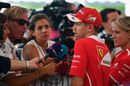 Sebastian Vettel talks with the media after Q1