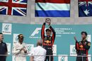 Race winner Max Verstappen celebrates on the podium with the trophy