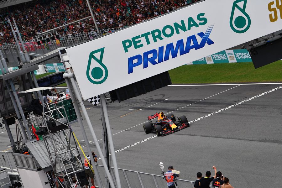 Race winner Max Verstappen crosses the line and takes the chequered flag