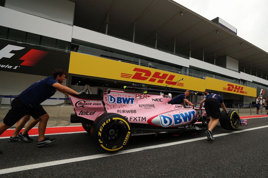 Force India mechanics with Force India VJM10 in pit lane