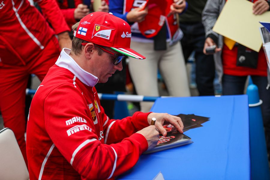 Kimi Raikkonen signs autographs for the fans