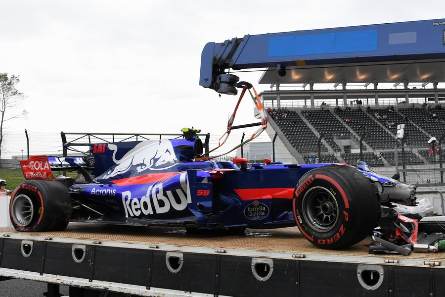 The crashed car of Carlos Sainz jr Toro Rosso STR12 is recovered after FP1