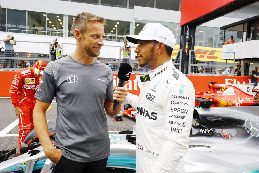 Pole sitter Lewis Hamilton talks with Jenson Button in parc ferme