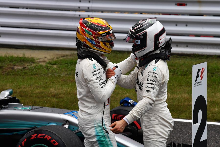 Pole sitter Lewis Hamilton and Valtteri Bottas celebrate in parc ferme