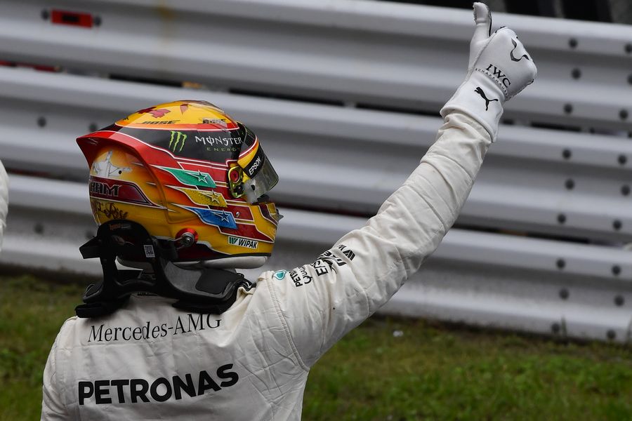 Pole sitter Lewis Hamilton celebrates in parc ferme