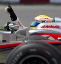 Lewis Hamilton celebrates alongside Jenson Button's McLaren