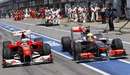 Lewis Hamilton and Fernando Alonso go wheel-to-wheel coming out the pits