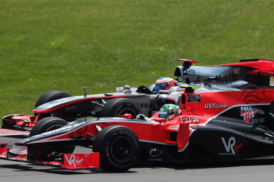 Lucas di Grassi is lapped by Jenson Button