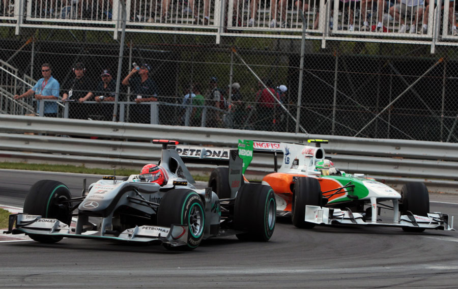 Michael Schumacher attempts to hold off Tonio Liuzzi 