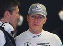 Nick Fry briefs Michael Schumacher before qualifying