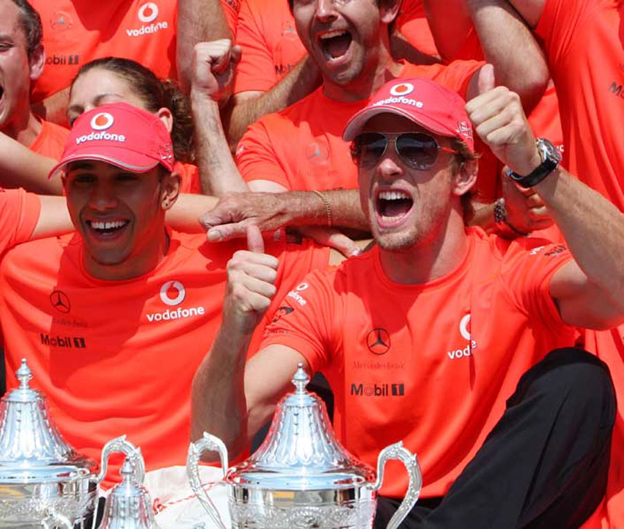 Lewis Hamilton and Jenson Button celebrate with the team
