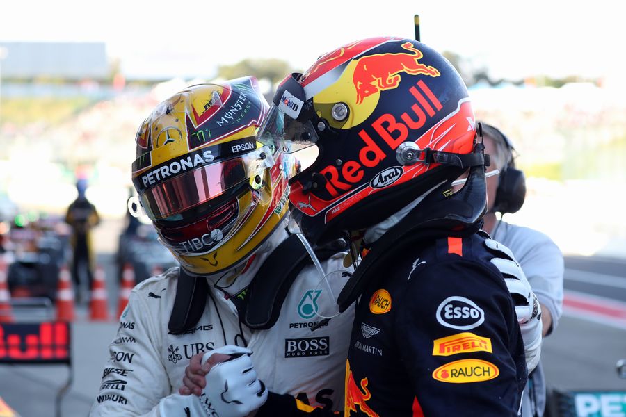 Race winner Lewis Hamilton celebrates with Max Verstappen in parc ferme