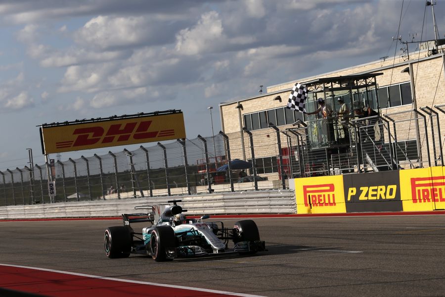 Lewis Hamilton takes the chequered flag at the end of Qualifying
