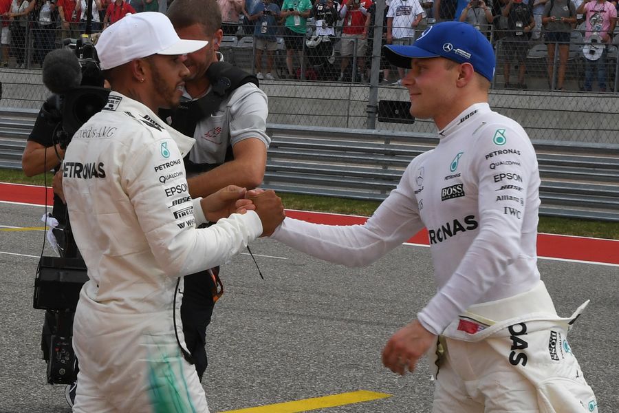 Pole sitter Lewis Hamilton and Valtteri Bottas celebrate in parc ferme