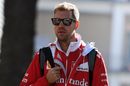 Sebastian Vettel walks through the paddock
