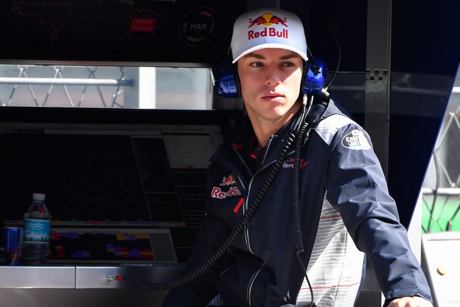 Pierre Gasly stands on the pit wall