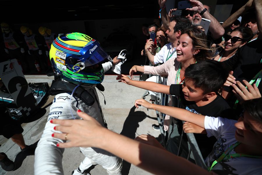 Felipe Massa celebrates his last Brazilian Grand Prix in parc ferme with his wife Rafaela Bassi and son Felipinho Massa